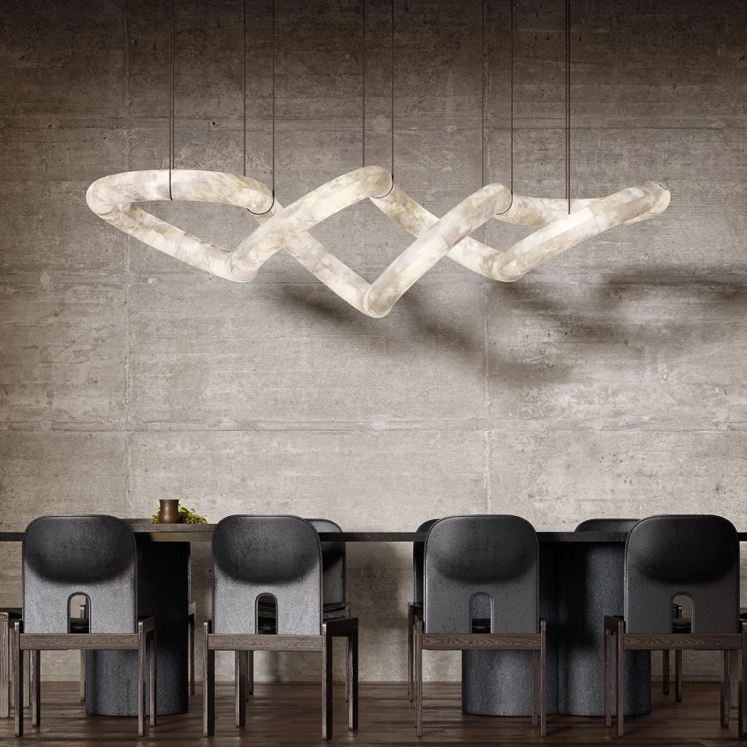 Infinite Glow alabaster chandelier interwoven twisted linear pendant light installed above dining table concrete wall interior