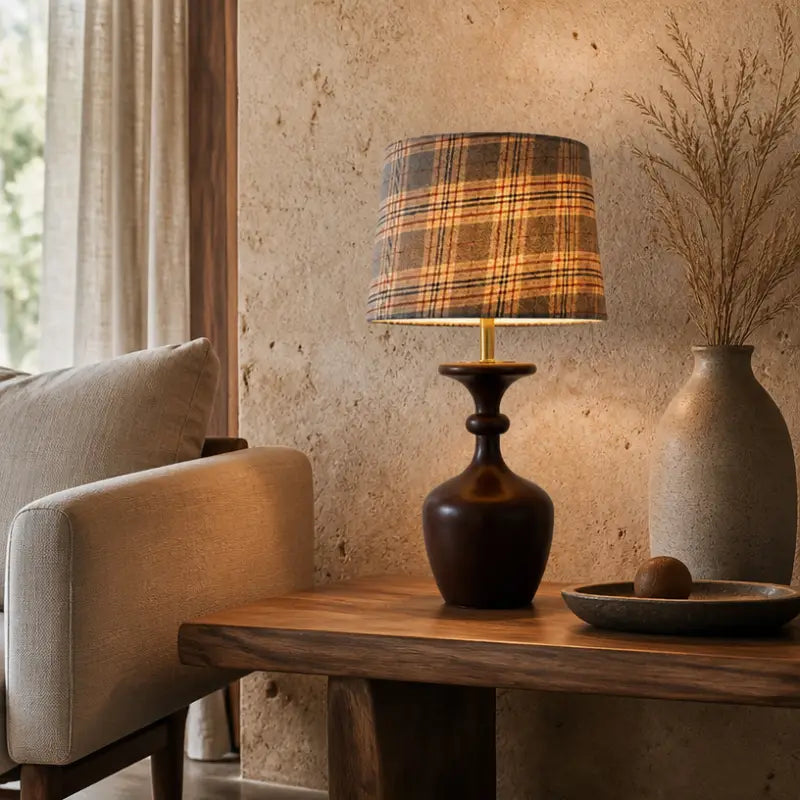 Rustic accent table lamp with checkered drum shade resting on a rough stone texture wall side table