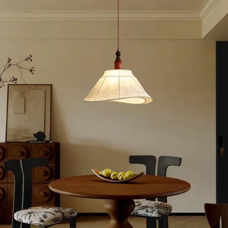 Elsira Tapered Pendant Lamp illuminating a dining area, featuring a sleek tapering silhouette and warm tones.