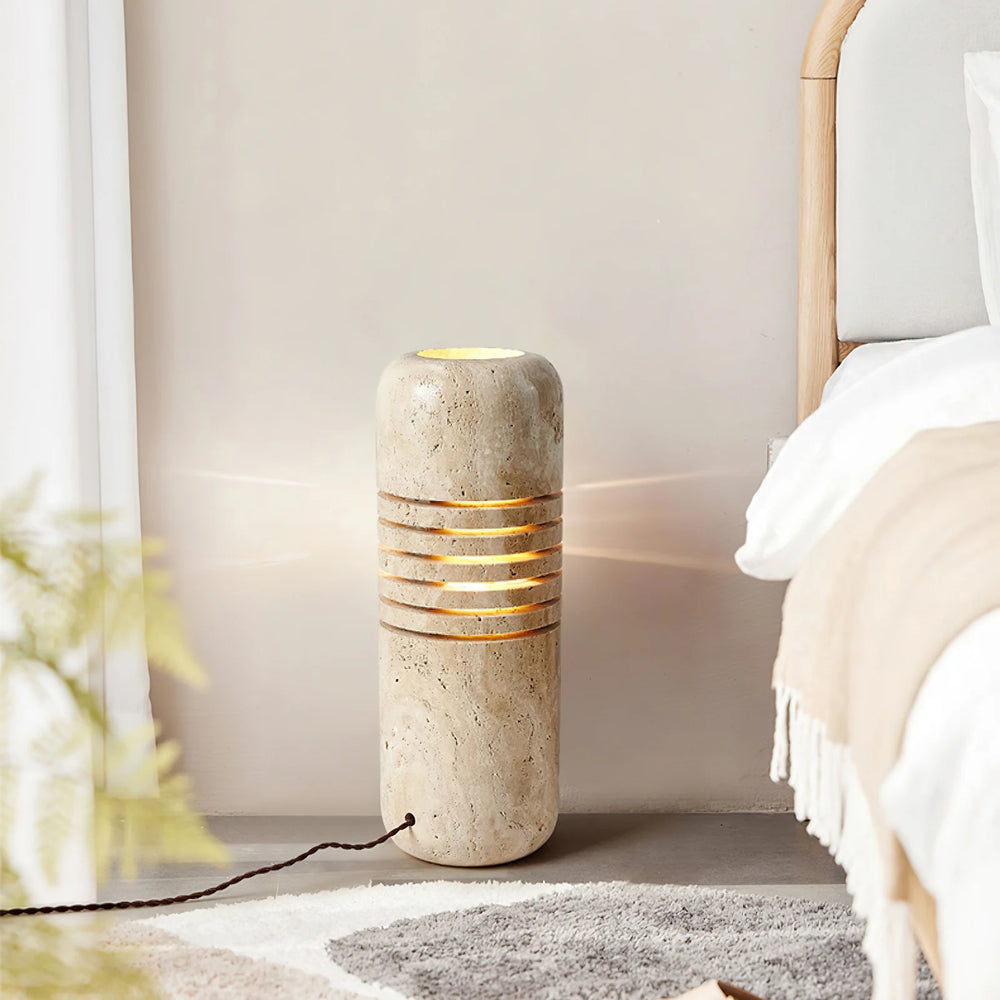 Travertine Bucket Floor Lamp in a modern bedroom setting, showcasing natural stone and warm light.