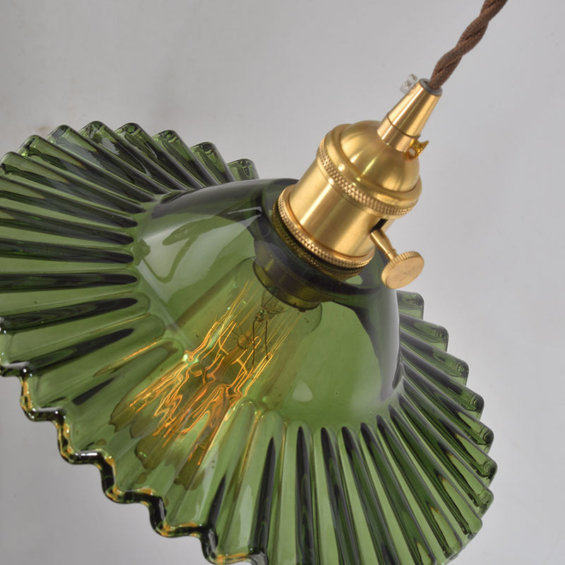 the detail of a small green glass lamp