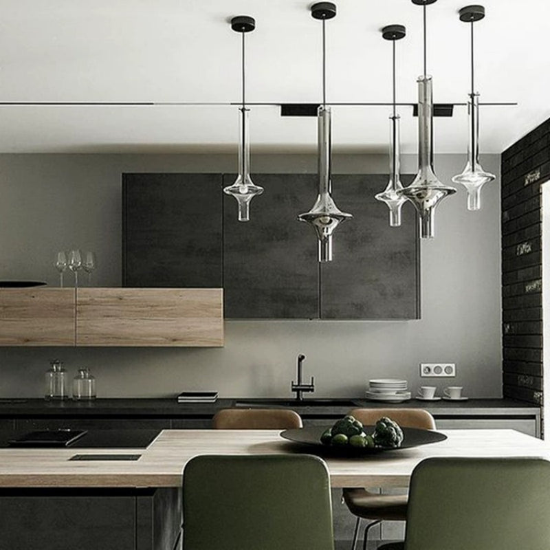 Miracle Star Pendant Lamp hanging over a modern kitchen island with green chairs and dark cabinetry for stylish lighting.