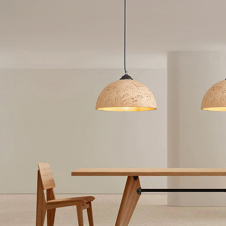 dome brown pendant light is above dining table