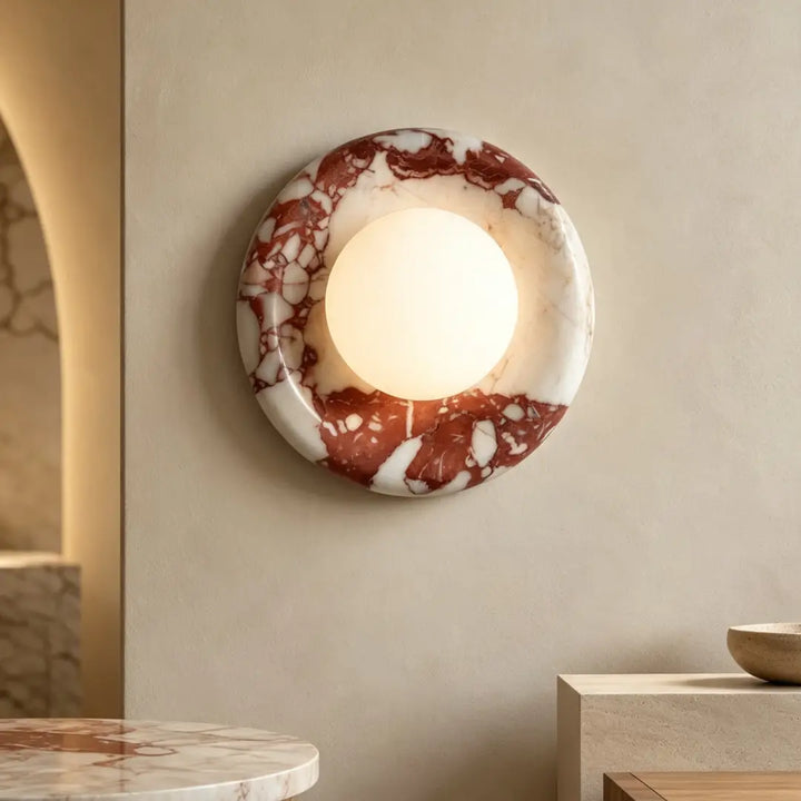 Modern Round Marble LED Wall Lamp warm glowing fixture on minimalist light living room wall with matching marble furniture
