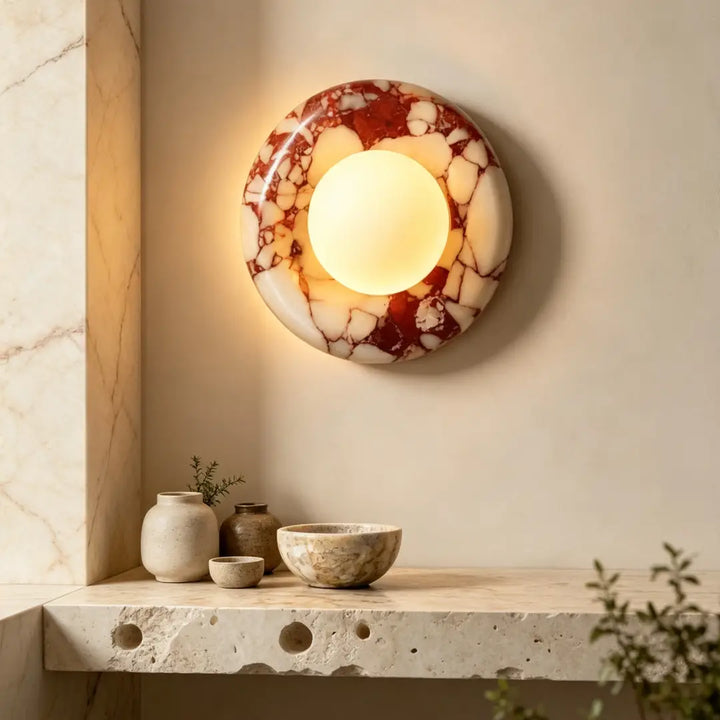Modern Round Marble LED Wall Lamp fixed on neutral cream entryway wall above travertine stone console table