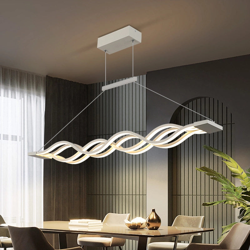 Modern Wave Pendant Light illuminating a dining room with a stylish, wavy design and warm glow.