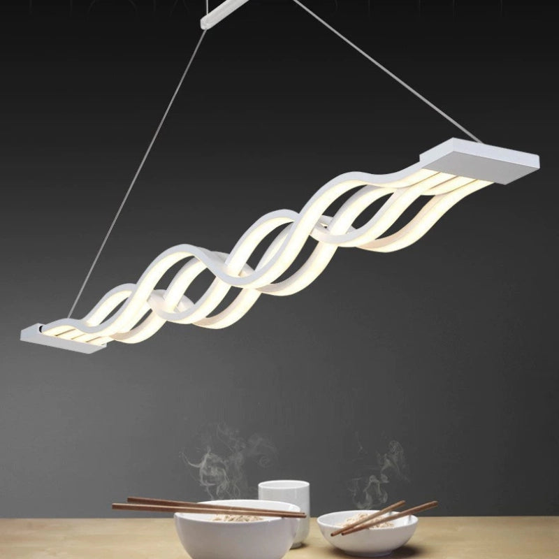 Modern Wave Pendant Light illuminating a dining table with steaming bowls and chopsticks, showcasing its elegant design.