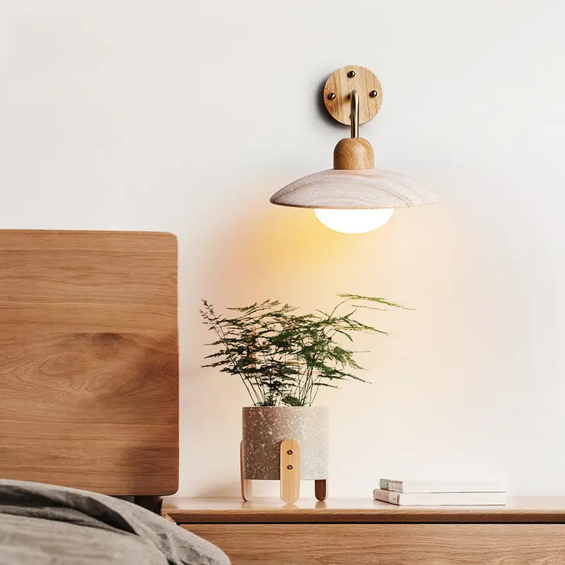 Modern Zarivo Wall Lamp illuminating a bedside table with a plant and wooden furniture.