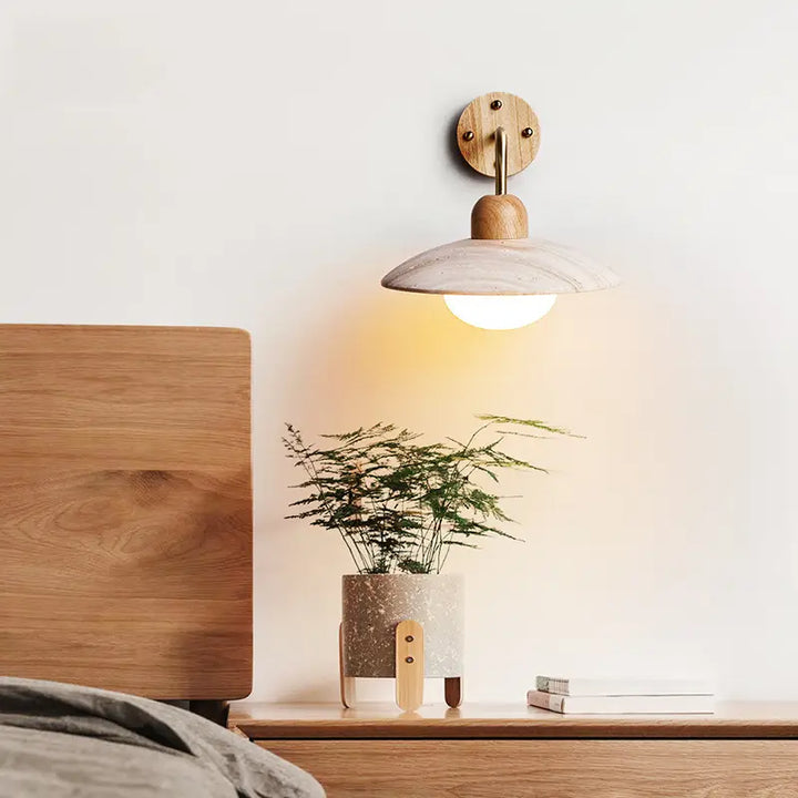 Modern Zarivo Wall Lamp illuminating a bedside table with a plant and wooden furniture.