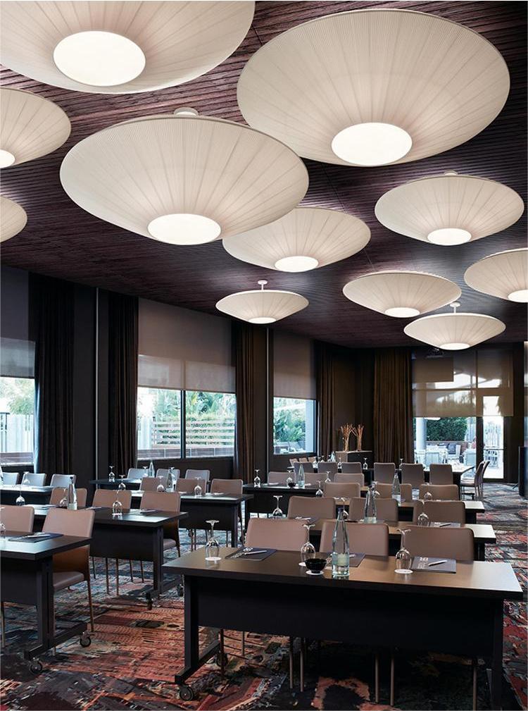 many round ceiling lamp made by cloth decorate the restaurant
