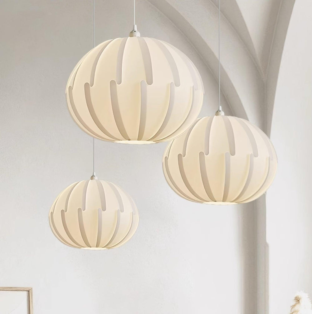 Elegant Cream Ribbed Pendant Light illuminating a stylish interior with three pendant fixtures.
