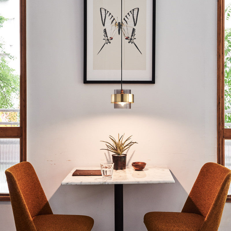 Glass dining pendant light decorates the dining table