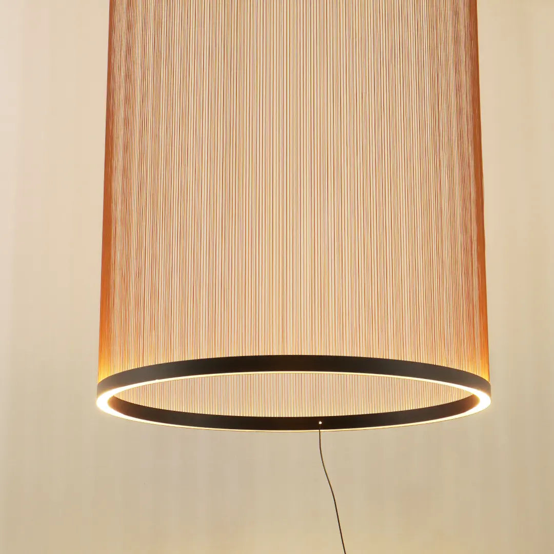 Spanish Cylinder Chandelier, tall cylindrical pendant lamp with vertical fabric‑string shade and glowing LED ring, warm ambient lighting for modern living room