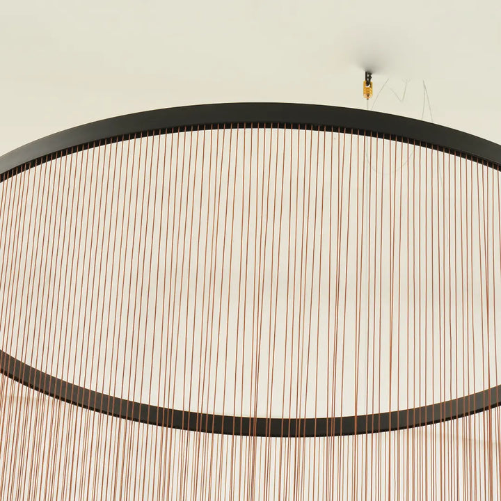Spanish Cylinder Chandelier, top‑angle close‑up of ceiling suspension fitting, black circular metal rim and fine vertical string curtain lampshade