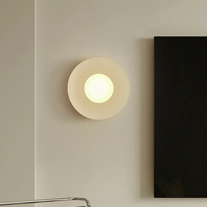 Beige wall lamp installed next to the TV