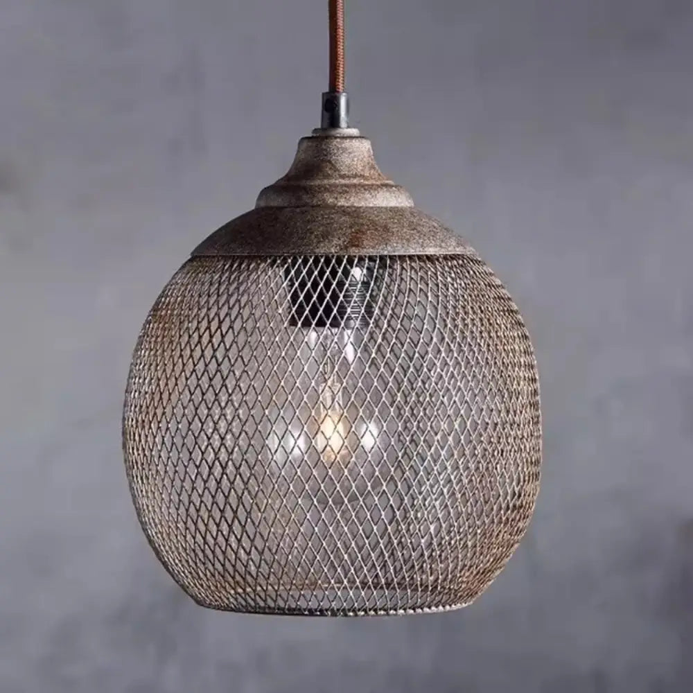 Close up of metal wire mesh sphere pendant lamp with antique bronze cap and woven texture