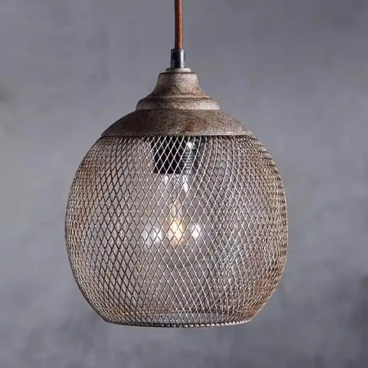 Close up of metal wire mesh sphere pendant lamp with antique bronze cap and woven texture