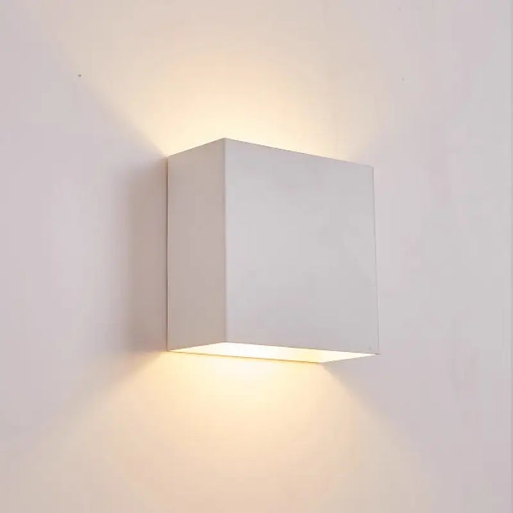 White Volex minimalist square LED wall lamp with clean cubic shape showing warm up and down light output for indoor modern wall lighting