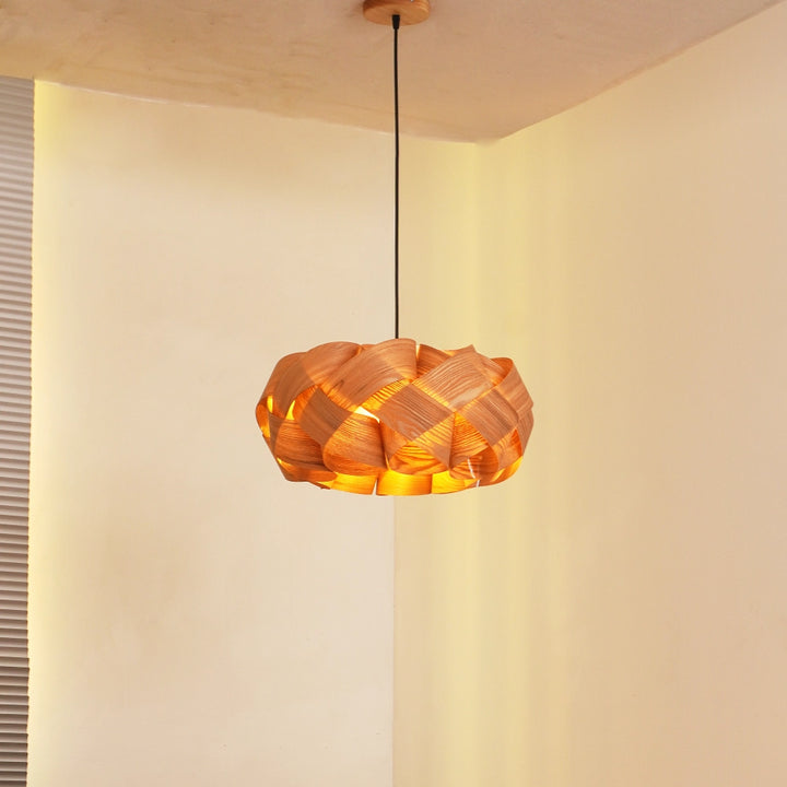 Wood Wave Pendant Light casting a warm glow, made from interwoven curved wood strips.