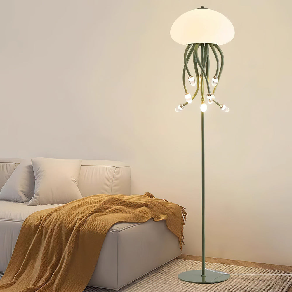 green jellyfish floor lamp with dome shade and glowing tentacles beside sofa with blanket in cozy room